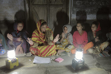 A night school in the village of Cheeri, lit by solar lanterns. Most of the students are girls from lower caste / untouchable backgrounds who must work in the fields during the day. Without the solar...