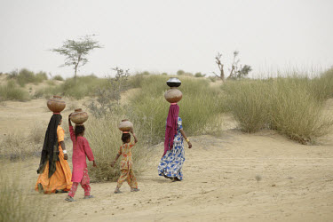 Women carrying water to their desert village.