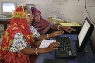 Norti (foreground), is a dalit (untouchable caste) and a semi-literate villager who now runs the Barefoot College's computer program that helps train other village women in computer skills.
