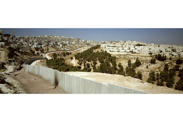 The Israeli separation wall / barrier runs between the Palestinian village of Shufat on the left and the Israeli settlement of Pisgat Ze'ev on the right.