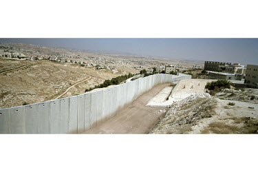The Israeli separation wall / barrier runs between the Palestinian village of Shufat on the right and the Israeli settlement of Pisgat Ze'ev on the left.