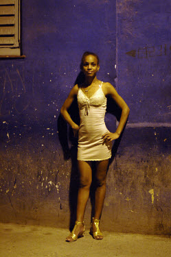 A sex worker waiting for customers in Centro Habana at night.