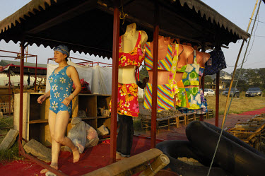 Private enterprise - a stand hiring out bathing costumes and providing changing rooms for tourists at a beach by the Li River.