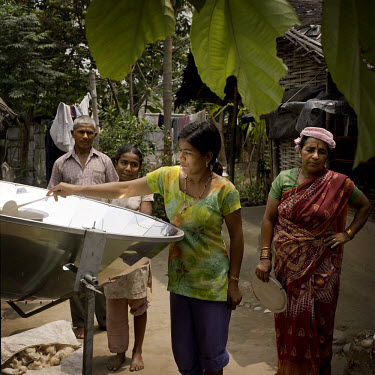 A family using a solar cooker at a Bhutanese refugee settlement. With the financial help of the Dutch Council for Refugees, a total of 6,300 solar cookers will be distributed amongst the Bhutanese ref...