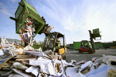 Paper from organised street collections are stockpiled at a recycling collection facility in West London.
