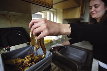 A woman sorting household waste.