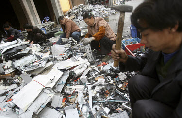 A group of migrant workers dismantle electronic devices at an e-waste recycling workshop. Every year Guiyu receives more than a million tons of computer waste from countries all over the world. About...