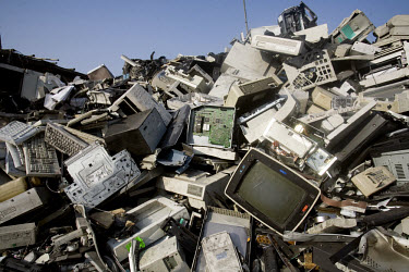 A pile of unsorted electronic trash lies on the road. Every year Guangdong receives more than a million tons of computer waste from countries all over the world. About 100,000 e-waste workers make the...