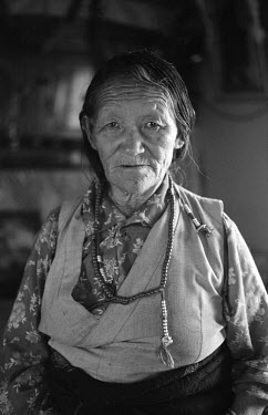 An old Tibetan woman, who was exiled from her homeland in 1959, at her home in Bir.