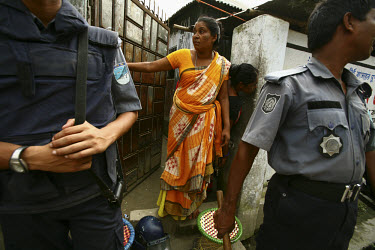 Police officers with anxious sex workers during eviction day at the Tangail brothel. The existence of the brothel is under threat from both Islamists and land grabbers. Many of the region's brothels,...