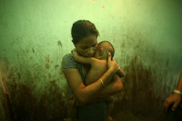 A sex worker with her daughter in a local brothel.