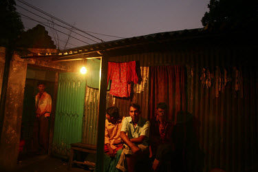 Clients waiting for sex workers in an alleyway. The men wander back and forth through these labyrinthine alleys in search of the most beautiful girls.
