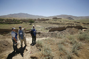 Members of the HALO Trust (Hazardous Areas Life-Support Organisation), an NGO involved in the clearing of unexploded ordnance (UXO), during an anti-personnel landmine search in a small village near Ba...