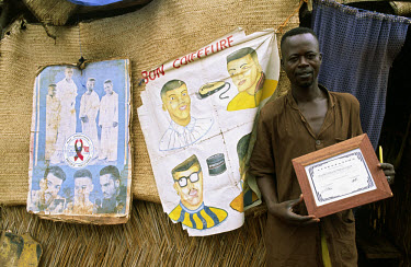A barber displaying his hairdressing diploma outside his shop.