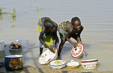 Bozo girls washing dishes in the Niger River.