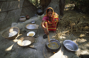 A cooperative member making popcorn to sell as part of an income generation programme.