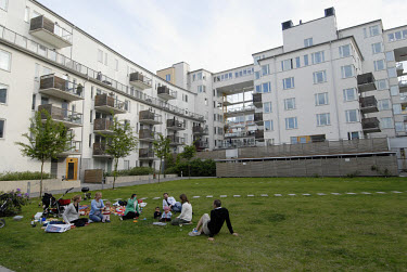 Residents relaxing outside a new luxury apartment building in Hammarby Sjostad. The Hammarby Sjostad district, a former brownfield site, is now being redeveloped to provide environmentally friendly, e...