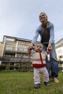 Charlotte Westlund and her nine-month-old baby, Selma, outside an apartment in Hammarby Sjostad. The Hammarby Sjostad district, a former brownfield site, is now being redeveloped to provide environmen...