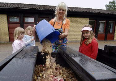 Children composting the remains of their school dinner at Skeppets Forskola primary school in Vaxjo, the lowest carbon emitting city in Europe. Environmental responsibility is taught at an early age h...