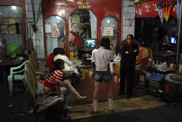 sex workers and their madam outside a brothel in Mong La, the capital of Special Region Number Four in eastern Shan State. Despite the fact that prostitution is officially illegal, there are many brot...