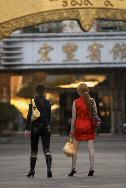 Two sex workers walk through the central town square in Mong La, the capital of Special Region Number Four in eastern Shan State. Many of Mong La's sex workers are either mainland Chinese or from the...