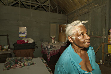 73-year-old Bernette Carter at home. The building was severely damaged by Hurricane Ivan and Bernette now lives with her daughter. She has received no government help with the repairs.