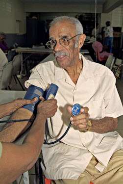 Nurse Ivy Holder checks the blood pressure of Dennis Magnus at Providence Methodist Day Centre.