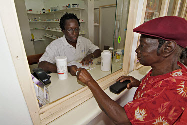 Lurline West getting her prescription drugs, which are subsidised by the government, at her local pharmacy.