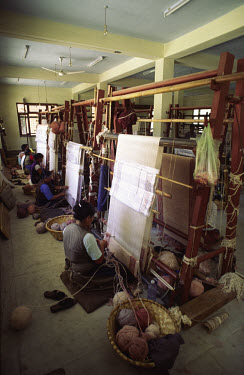 Tibetan refugee women weaving carpets.