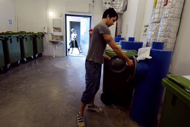 A resident pours his rubbish into a garbage disposal chute outside his apartment block in Hammarby Sjostad. The Hammarby Sjostad district, a former brownfield site, is now being redeveloped to provide...