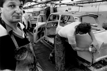 Labourers working on the production of the last few Trabant cars at the VEB Sachsenring Automobilwerke factory. VEB Sachsenring, an East German car manufacturer, ceased production of its iconic Traban...