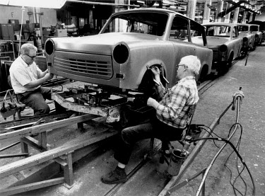 Labourers working on the production of the last few Trabant cars at the VEB Sachsenring Automobilwerke factory. VEB Sachsenring, an East German car manufacturer, ceased production of its iconic Traban...