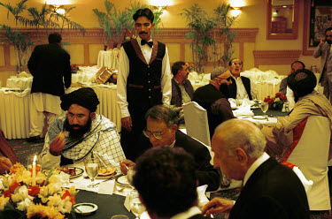 An Iftar dinner at the Marriott hotel organised by the Muslim World Congress. The iftar meal is held after sundown during Ramadan. Seated at left is Mullah Abdul Salam Zaeef, the Taliban ambassador in...