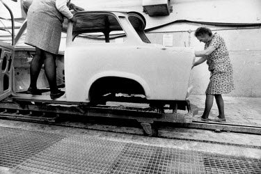 Female labourers working on the production of the last few Trabant cars at the VEB Sachsenring Automobilwerke factory. VEB Sachsenring, an East German car manufacturer, ceased production of its iconic...