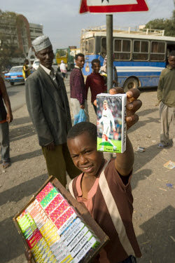A young boy selling unofficial David Beckham tissues in the street. Football is extremely popular in Ethiopia and some European teams have huge followings.