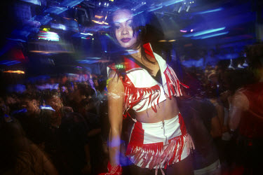 A young girl dancing in a nightclub.