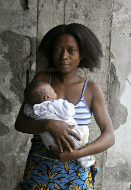 A young mother with her baby who lives with her family in what was once a bank. Soon these displaced people will have to move and find another place to live as many of these squatted buildings are bei...