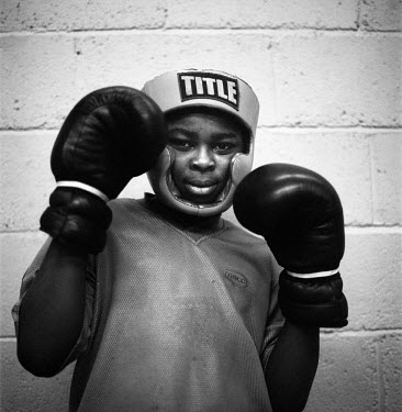 Quadri poses before a bout. The Boys to Men project in Peckham, South London is an intervention project for inner city boys involved in street gangs. It aims to divert them away from the dangers of 't...