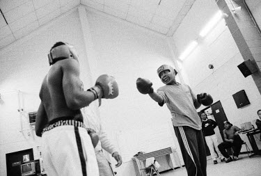 Kyle (right) and Leon before the start of their boxing contest. The Boys to Men project in Peckham, South London is an intervention project for inner city boys involved in street gangs. It aims to div...
