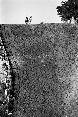 Johnathon Abrahamson, aka Jonny Cakes, stands with his horse The Rock on top of Suicide Hill - a 210 feet drop - before the fourth and final race. Johnathan won the race and with it the Omak Suicide C...