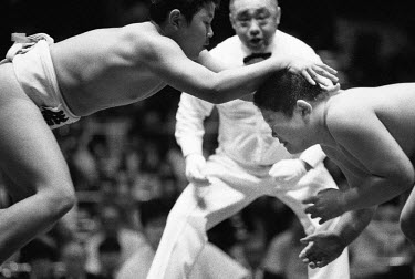 A Young Rikishi Sumo wrestler attempts to push his opponent to the floor. 450 children, aged between 11-14 qualified for the All Japan Wanpaku Sumo Tournament held in the Ryogoku Kokugikan Stadium.