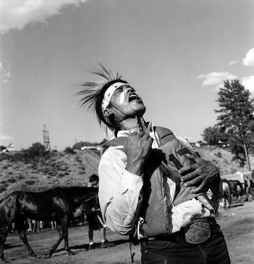 Winfred Pakootas makes a warrior cry at the end of the final Suicide Race. The Omak Suicide Race is part of the Omak Stampede, a rodeo which is held on the Colville Native American / Indian Reservatio...