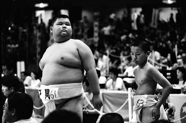 Two Young Rikishi Sumo competitors wait for their contest. 450 children, aged between 11-14, qualified for the All Japan Wanpaku Sumo Tournament held at the Ryogoku Kokugikan Stadium.