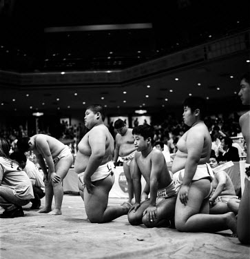 Young Rikishi Sumo competitors wait beside the Dohyo before their contest. 450 children, aged between 11-14, qualified for the All Japan Wanpaku Sumo Tournament held at the Ryogoku Kokugikan Stadium.