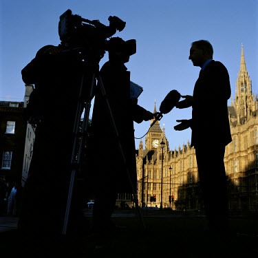 A politician is interviewed for television in Abington Street Gardens outside the Houses of Parliament, London. Abingdon Street Gardens, often referred to as College Green, is the small patch of land...