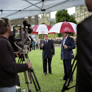 Former Deputy Prime Minister John Prescott shelters under an umbrella whilst waiting to talk to the BBC on the day Gordon Brown took over as British Prime Minister. Abingdon Street Gardens, often refe...