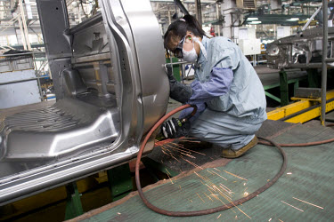Workers on the assembly line at the Hebei Zhongxing Automobile Company (ZXAuto) car factory in Baoding.