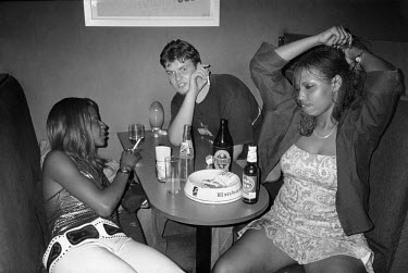 A white man in a nightclub in Kigali. Clubs now are crowded with sex workers, many of whom are girls who lost their parents after the genocide of 1994 and are trying to make a living.