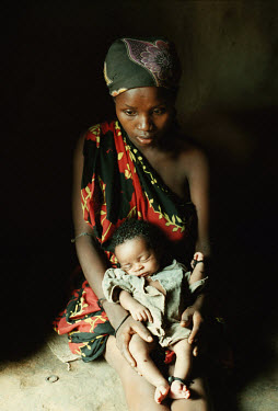 Sixteen year old Amina Hurar holds her second child, 20-day-old  Hasan, in her arms. Due to the famine, Amina's diet is such that she is unable to provide breast milk for her baby.