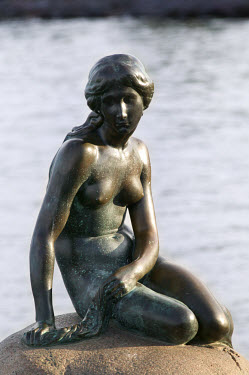 A statue of the Little Mermaid on a rock in Copenhagen's harbour.